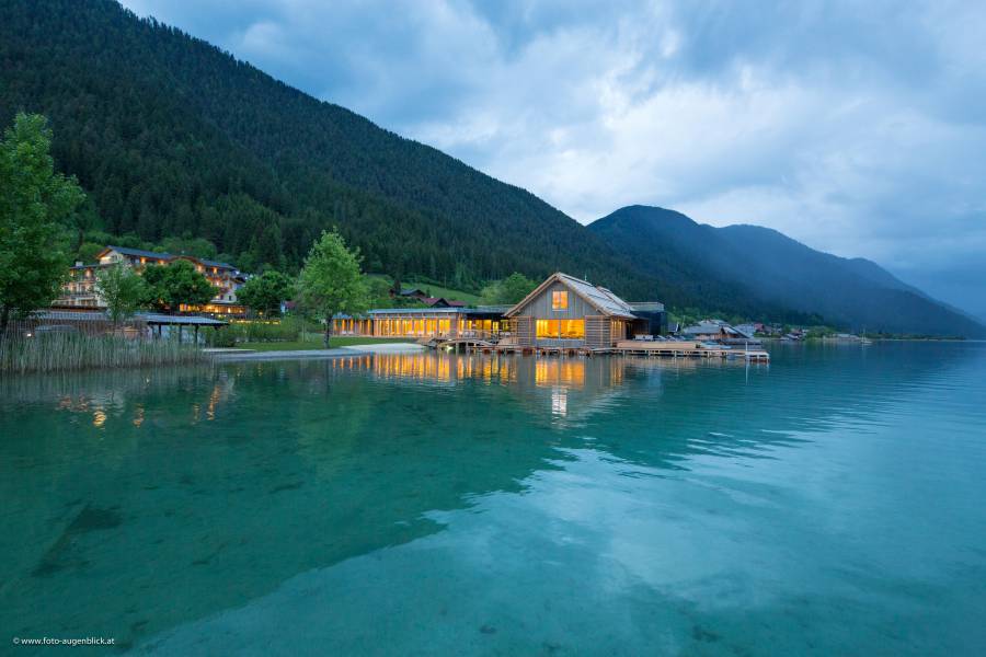 Illuminated external evening view of the lake-spa Strandhotel am Weissensee